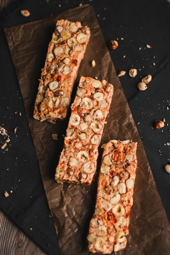 Homemade survival food bars made with oats and nuts, displayed on parchment paper for DIY emergency prepping.