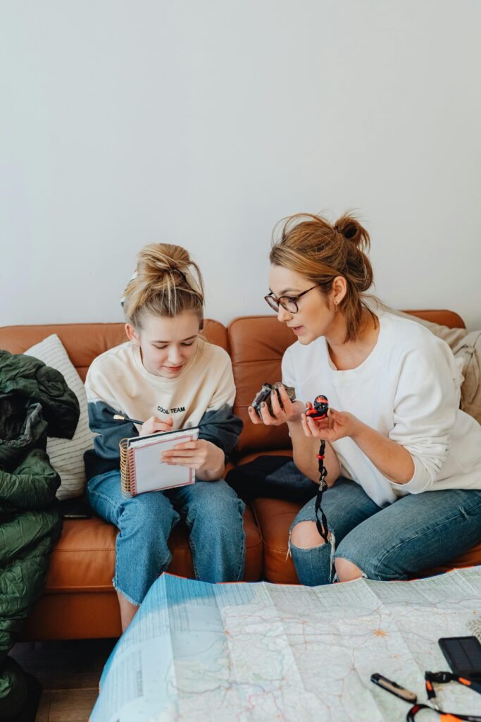 family emergency communication plan | Backyard Bug Out A mother and daughter sitting down and going over their family emergency communication plan.