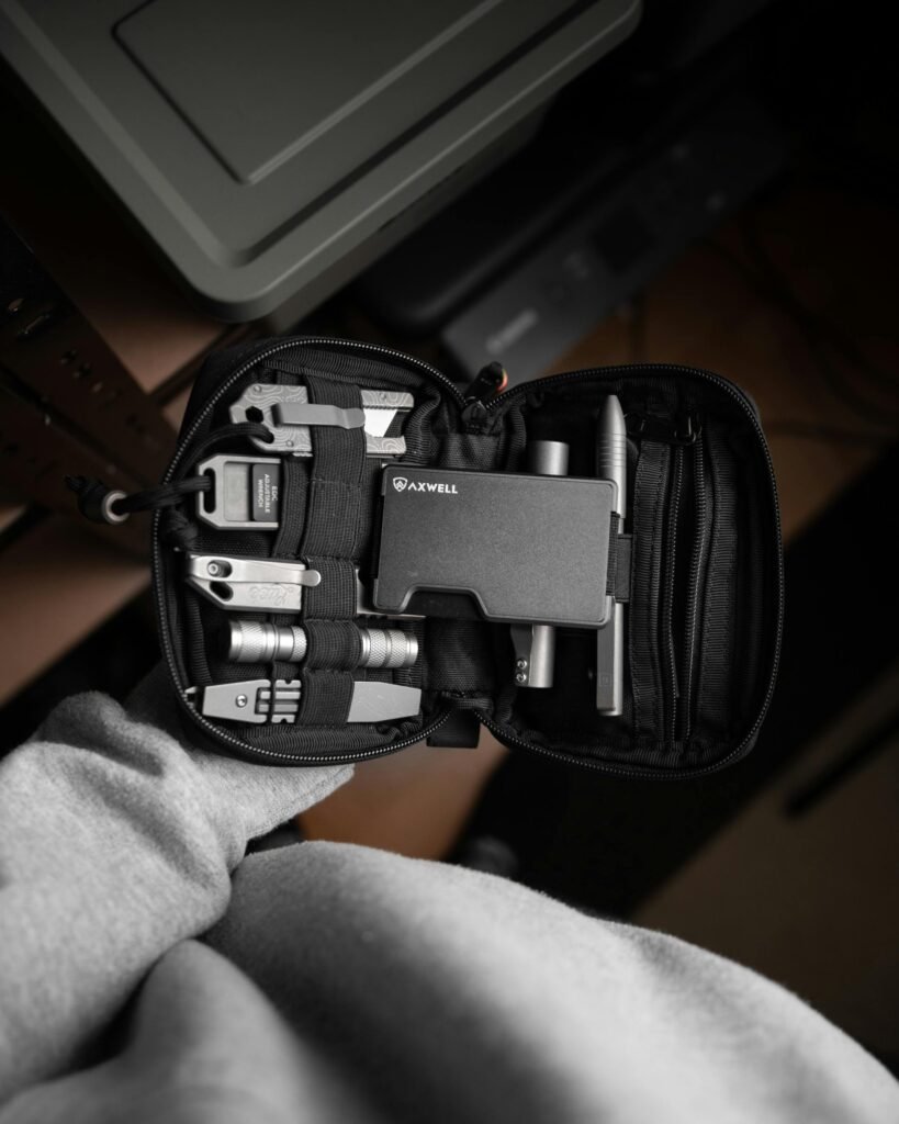 Everyday carry for preppers gear setup with multitool, flashlight, and tactical wallet on a table