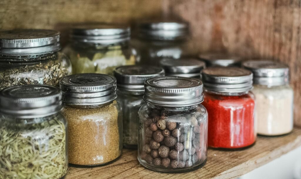 Glass jars of dried herbs and medicinal plants for backyard medicine and natural remedies.